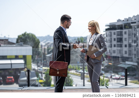 Woman and man in official style suit walking outdoor buildings discussing new architect projects 116989421
