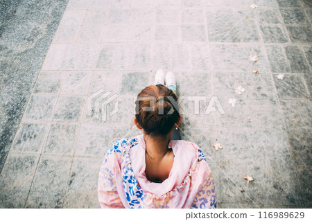 Top view of Asian determined woman in jacket sportswear stretching for flexibility in outdoor park. This exercise moves can be warm up or cool down before sports activity 116989629