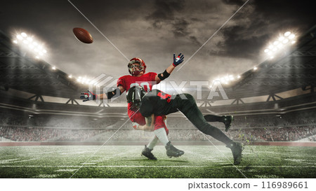 Dynamic image of two American football players in motion on open air arena with filled stands, competing for victory. 3D render of stadium 116989661