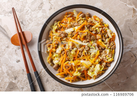 Eggroll in a bowl sauteed ground meat with vegetables in flavor packed sauce closeup. Horizontal top view 116989706