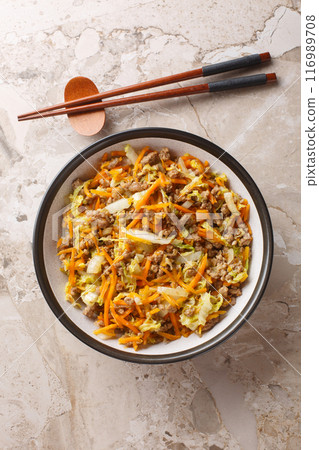 One Pot Egg Roll Bowl with beef, onion, carrot, cabbage closeup. Vertical top view One Pot Egg Roll Bowl with beef, onion, carrot, cabbage closeup. Vertical top view 116989708