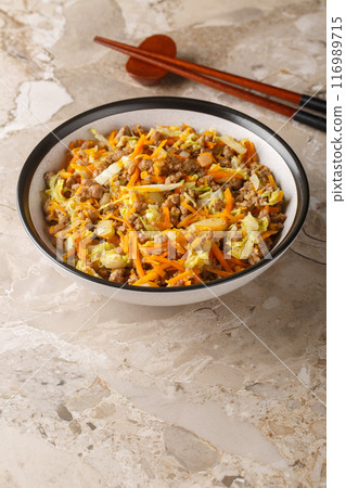 Egg roll bowl with vegetables and meat traditional asian food in one pot close-up. Vertical 116989715