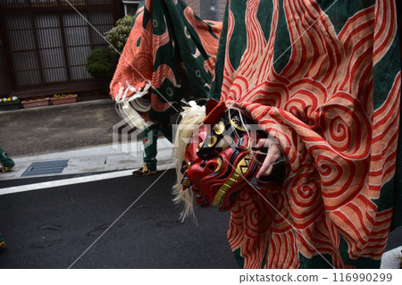 Takayama City, Gifu Prefecture, Japan: Traditional performing arts at the Takayama Spring Festival. Lion dancers parade through the streets in festival costumes, shaking the lion's face. 116990299
