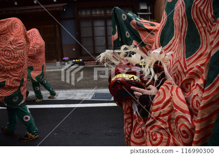 Takayama City, Gifu Prefecture, Japan: Traditional performing arts at the Takayama Spring Festival. Lion dancers parade through the streets in festival costumes, shaking the lion's face. 116990300