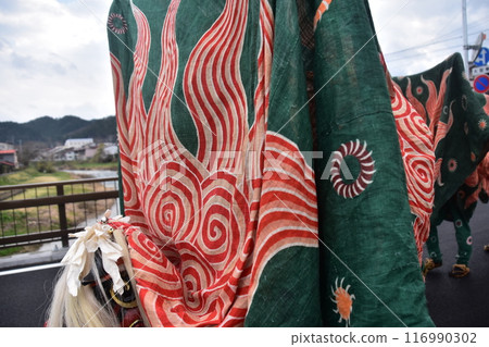 Takayama City, Gifu Prefecture, Japan: Traditional performing arts at the Takayama Spring Festival. Lion dancers parade through the streets in festival costumes, shaking the lion's face. 116990302