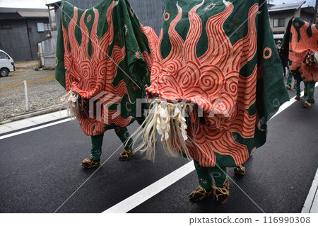 Takayama City, Gifu Prefecture, Japan: Traditional performing arts at the Takayama Spring Festival. Lion dancers parade through the streets in festival costumes, shaking the lion's face. 116990308
