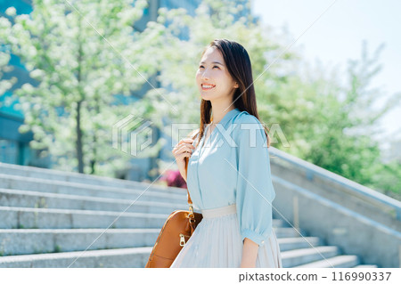 Business woman going up the stairs Business woman going up the stairs 116990337