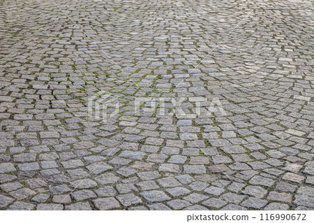 Old cobblestone pavement. Stone vintage paved road. Background perspective Old cobblestone pavement. Stone vintage paved road. Background perspective 116990672