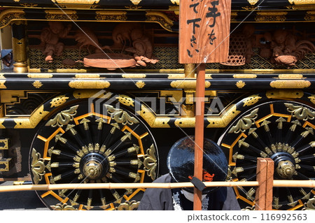 Takayama City, Gifu Prefecture, Japan: Spring Takayama Festival: A gorgeous float called a yatai, with beautiful decorations and a male participant waiting wearing a jinbaori 116992563
