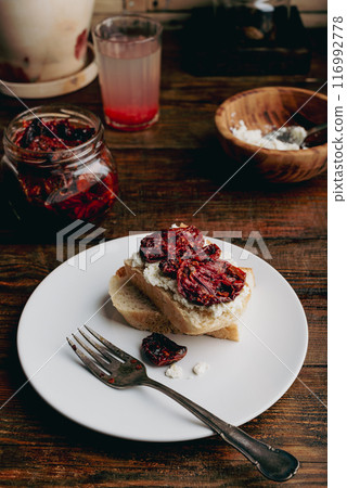 White bread with sun-dried tomatoes and cream cheese 116992778