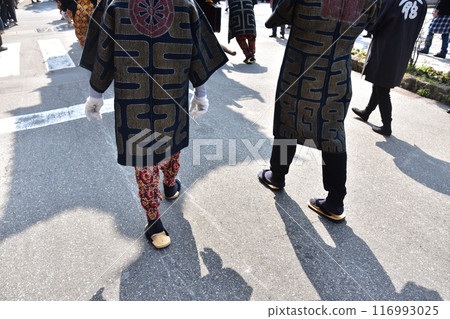 Takayama Festival in Spring, Takayama City, Gifu Prefecture, Japan. People participating in the festival wearing colorful happi coats, feet wearing tabi socks and straw sandals. Takayama Festival in Spring, Takayama City, Gifu Prefecture, Japan. People participating in the festival wearing colorful happi coats, feet wearing tabi socks and straw sandals. 116993025