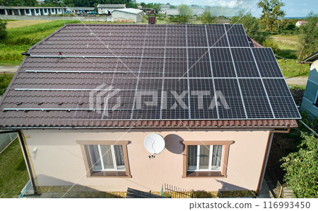 Photovoltaic solar panel fading away and shifting into metal supporting structure. Transition between metal rails and solar modules on roof of house. Concept of alternative energy sources. Aerial view 116993450