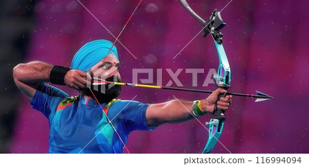 Focused Indian men, archery athlete drawing bow directly into target. Competitive spirit 116994094