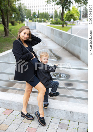 Pregnant mother and her little son walking and funny spending time together Pregnant mother and her little son walking and funny spending time together 116994163