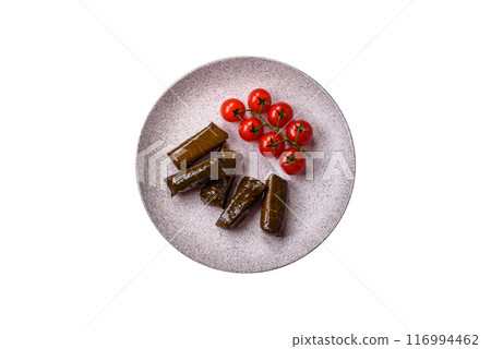 Delicious dolma in the form of rice and meat wrapped in grape leaves Delicious dolma in the form of rice and meat wrapped in grape leaves 116994462