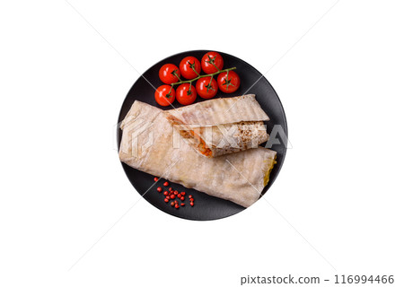 Delicious juicy roll or shawarma with chicken, tomatoes, salad and sauce 116994466