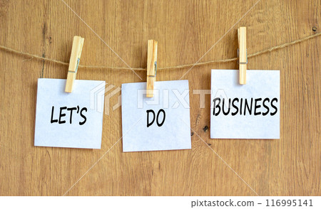 let is do business symbol. Concept words let is do business on beautiful white paper on clothespin. Beautiful wooden table wooden background. let is do business concept. Copy space. 116995141