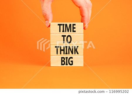 Time to think big symbol. Concept words Time to think big on beautiful wooden block. Beautiful orange table orange background. Businessman hand. Business and time to think big concept. Copy space. 116995202
