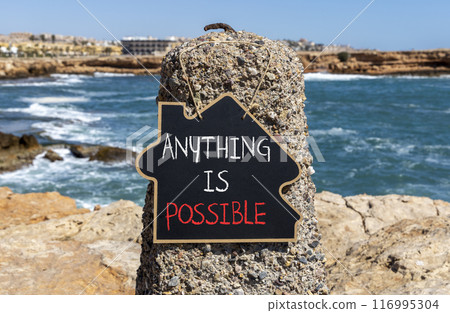 Anything is possible symbol. Concept words Anything is possible on beautiful black chalk blackboard. Beautiful red stone blue sea sky background. Business anything possible concept. Copy space. 116995304
