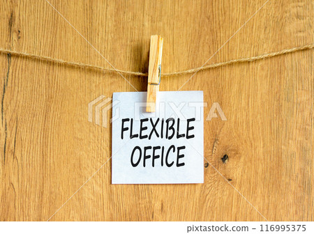 Flexible office symbol. Concept words Flexible office on beautiful white paper on wooden clothespin. Beautiful wooden background. Business Flexible office concept. Copy space. 116995375