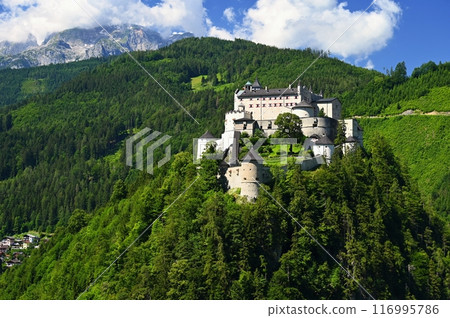 A landscape with nature and a beautiful old castle. Hohenwerfen medieval castle towering over the Austrian town of Werfen. A landscape with nature and a beautiful old castle. Hohenwerfen medieval castle towering over the Austrian town of Werfen. 116995786