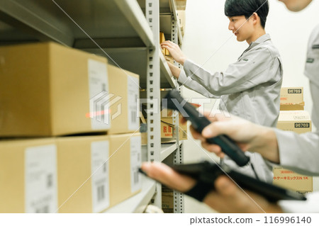 A male manager manages warehouse entry and exit on a terminal A male manager manages warehouse entry and exit on a terminal 116996140