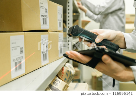 A male manager manages warehouse entry and exit on a terminal A male manager manages warehouse entry and exit on a terminal 116996141