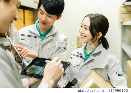 Young workers discussing shipping schedules 116996160