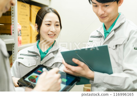 Young workers discussing shipping schedules Young workers discussing shipping schedules 116996165