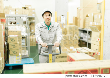Warehouse manager moving pallets with jack Warehouse manager moving pallets with jack 116996170
