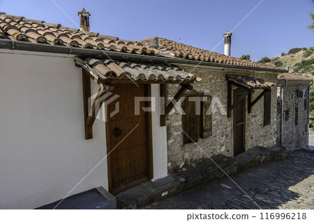 Greece, Nikiti, Street of the old town of Nikiti with its stone houses. Greece, Nikiti, Street of the old town of Nikiti with its stone houses. 116996218