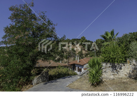 Greece, Nikiti, Street of the old town of Nikiti with its stone houses. 116996222