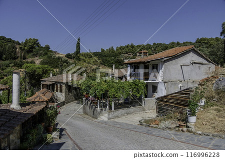 Greece, Nikiti, Street of the old town of Nikiti with its stone houses. Greece, Nikiti, Street of the old town of Nikiti with its stone houses. 116996228