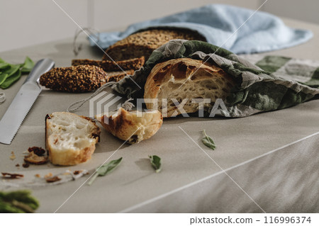 Sliced bread on wooden board in linen bag close up. Kitchen aesthetic concept Sliced bread on wooden board in linen bag close up. Kitchen aesthetic concept 116996374