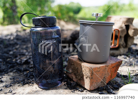 Outback Line Water Bottle and Coffee Press on a Sunny Day 116997740