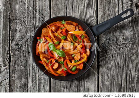 zesty italian sausage peppers and onions, top view zesty italian sausage peppers and onions, top view 116998615
