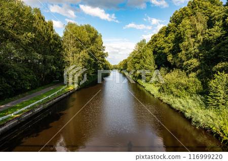 Perspective view over the Zuid Willmesvaart canal with tree reflections around Lieshout, North Brabant, The Netherlands 116999220