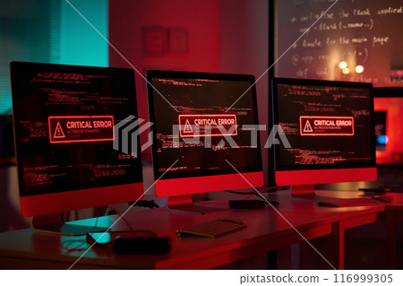 Background image of three computer monitors with emergency messages on screen in red lights copy space 116999305