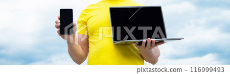 cropped view of man offering smartphone and laptop on sky background 116999493