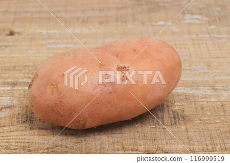 Fresh Organic Sweet Potato Placed Beautifully on a Wooden Surface for an Aesthetic Appeal Fresh Organic Sweet Potato Placed Beautifully on a Wooden Surface for an Aesthetic Appeal 116999519