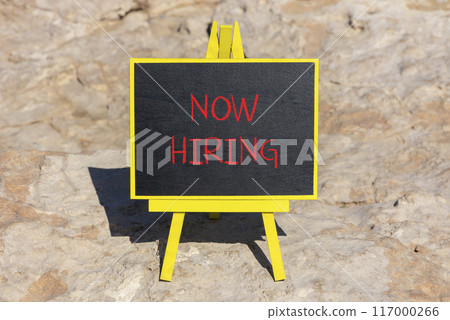 Now hiring symbol. Concept words Now hiring on beautiful black chalk blackboard. Beautiful sea stone beach background. Business marketing, motivational now hiring concept. Copy space. Now hiring symbol. Concept words Now hiring on beautiful black chalk blackboard. Beautiful sea stone beach background. Business marketing, motivational now hiring concept. Copy space. 117000266