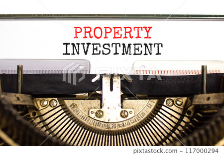 Property investment symbol. Concept words Property investment typed on beautiful old retro typewriter. Beautiful white paper background. Business Property investment concept. Copy space. 117000294