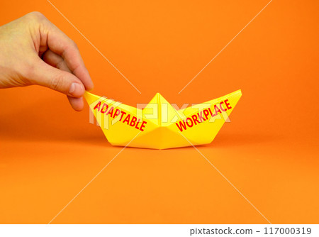 Adaptable workplace symbol. Concept words Adaptable workplace on beautiful yellow paper boat. Beautiful orange paper background. Businessman hand. Business Adaptable workplace concept. Copy space. Adaptable workplace symbol. Concept words Adaptable workplace on beautiful yellow paper boat. Beautiful orange paper background. Businessman hand. Business Adaptable workplace concept. Copy space. 117000319