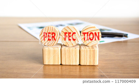 Perfection symbol. Concept word Perfection on beautiful wooden circles. Beautiful wooden table white background. Black pen. White document. Business perfection concept. Copy space. Perfection symbol. Concept word Perfection on beautiful wooden circles. Beautiful wooden table white background. Black pen. White document. Business perfection concept. Copy space. 117000409