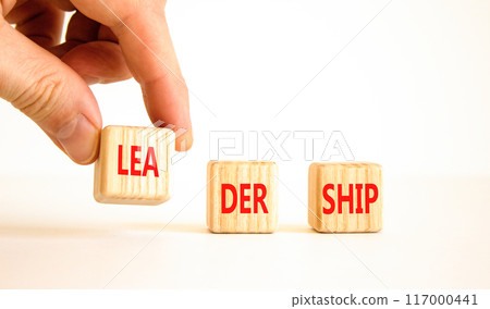 Leadership symbol. Concept word Leadership on beautiful wooden blocks. Businessman hand. Beautiful white background. Business leadership concept. Copy space. 117000441