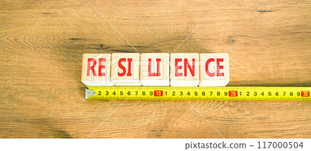 Resilience symbol. Concept word Resilience on beautiful wooden cubes. Beautiful wooden background. Beautiful yellow ruler. Business resilience concept. Copy space. 117000504