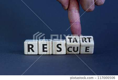 Rescue and restart symbol. Businessman hand turns cubes and changes the word 'rescue' to 'restart'. Beautiful grey background. Business and rescue - restart concept. Copy space. Rescue and restart symbol. Businessman hand turns cubes and changes the word 'rescue' to 'restart'. Beautiful grey background. Business and rescue - restart concept. Copy space. 117000506