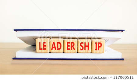 Leadership symbol. Concept word Leadership on beautiful wooden cubes in book. Beautiful wooden table white background. Business leadership concept. Copy space. Leadership symbol. Concept word Leadership on beautiful wooden cubes in book. Beautiful wooden table white background. Business leadership concept. Copy space. 117000511