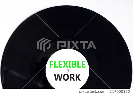 Flexible work symbol. Concept words Flexible work on beautiful white black vinyl disk. Beautiful white paper background. Business Flexible work concept. Copy space. Flexible work symbol. Concept words Flexible work on beautiful white black vinyl disk. Beautiful white paper background. Business Flexible work concept. Copy space. 117000550