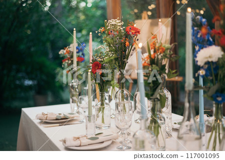Decorated atmospheric table for a conservatory wedding. The concept of serving and decorating the holiday 117001095